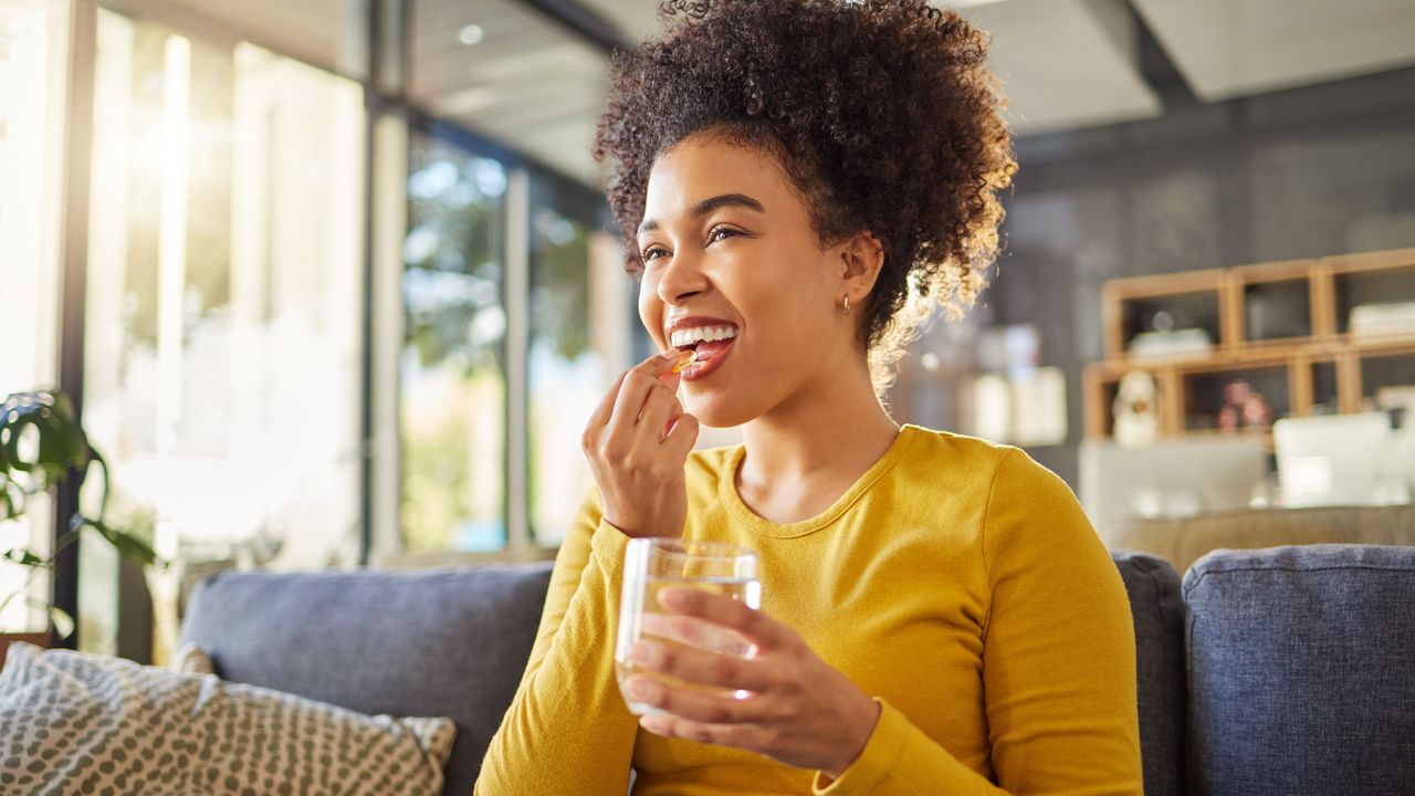 Woman taking one of the best vitamin D supplements