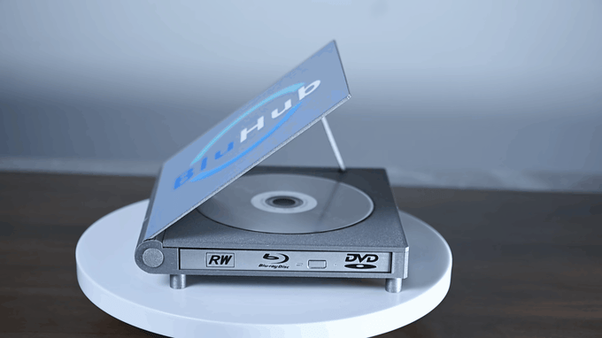 The BluHub rotating on a white plinth on a dark surface