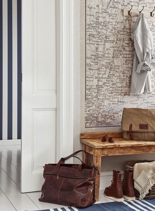 map on wall with white door bag and shoes