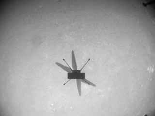 An image the Mars helicopter Ingenuity captured of its shadow during its eighth flight on Mars, on June 21, 2021.