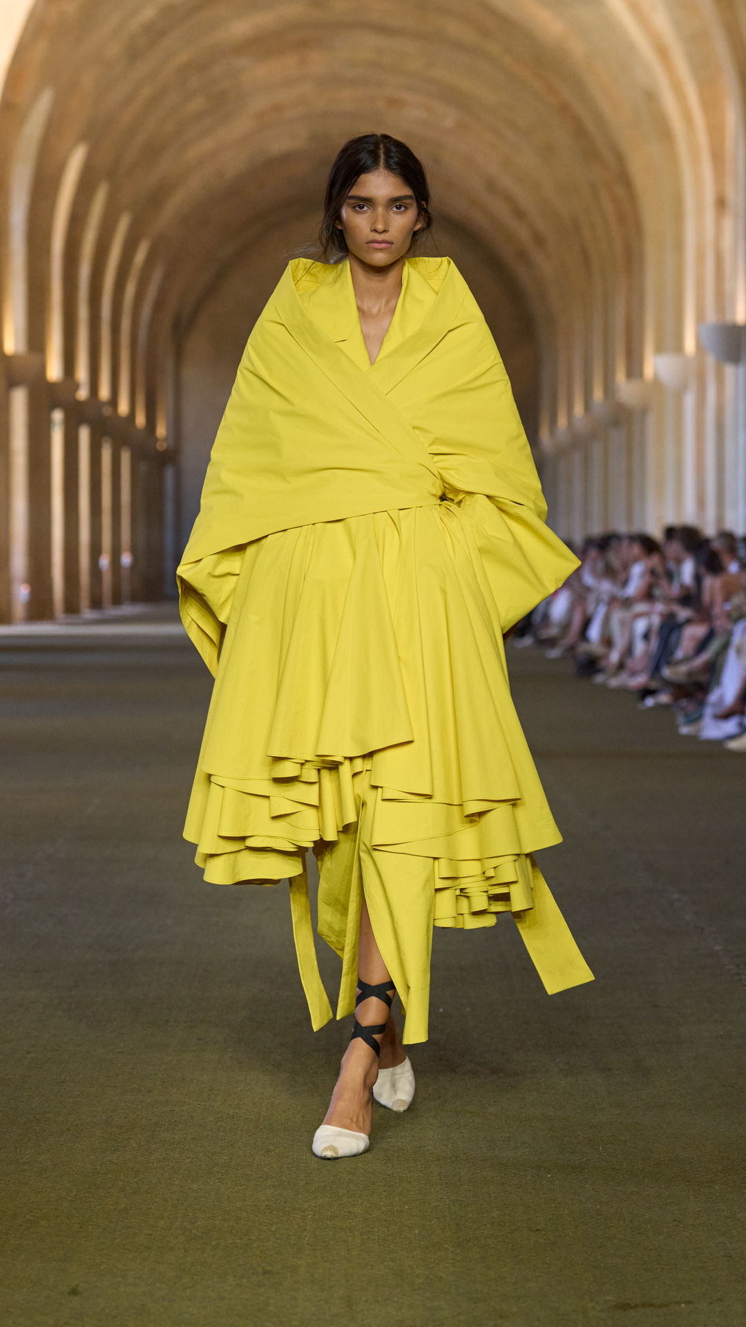 A woman walks the jacquemus s/s 26 show.
