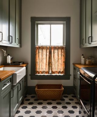 laundry with butlers sink and black and white tiles