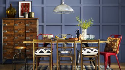 dining room with blue pattern wallpaper and rattan pendant shade