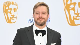 Iain Stirling attends the 2024 BAFTA Television Awards in a tux with a white shirt.