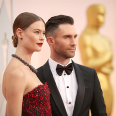 Recording artist Adam Levine (R) and Behati Prinsloo attend the 87th Annual Academy Awards at Hollywood & Highland Center on February 22, 2015 in Hollywood, California. 