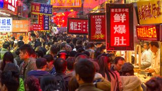 An image of a bustling market at night in Bejing, China. 