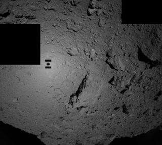 Japan’s Hayabusa2 spacecraft snapped this photo at about midnight EDT on Sept. 21, 2018, around the time it deployed the two tiny MINERVA-II1 hoppers toward the surface of the asteroid Ryugu. Hayabusa2’s shadow is clearly visible.