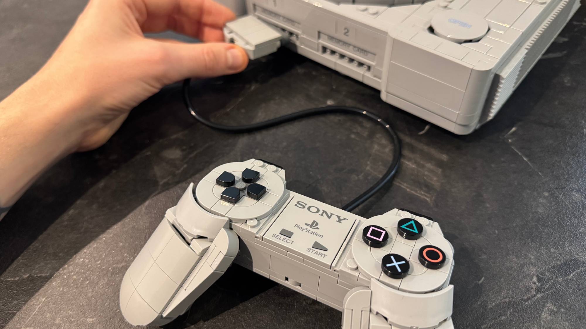 Lego PlayStation model showing the controller being plugged in