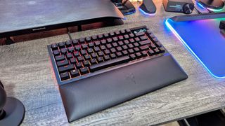 The Razer BlackWidow V4 Pro 75% on a desk with its wrist rest.