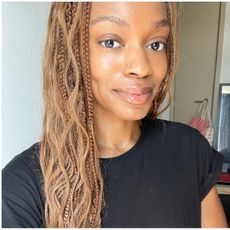 a person with brown hair in front of a white background