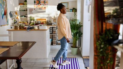 Woman doing ageing test at home in kitchen