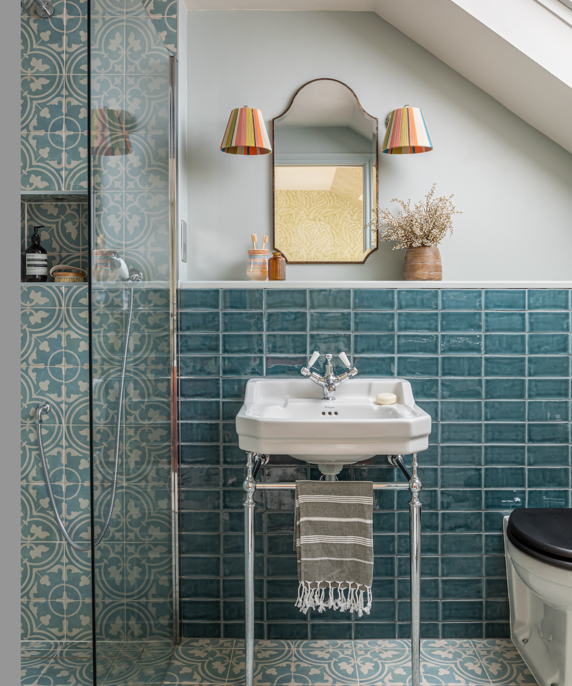 A blue bathroom with pale blue walls and baby blue tiles