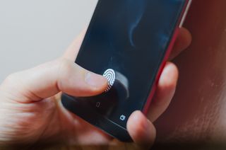 A smartphone with a fingerprint scanner displayed on the screen