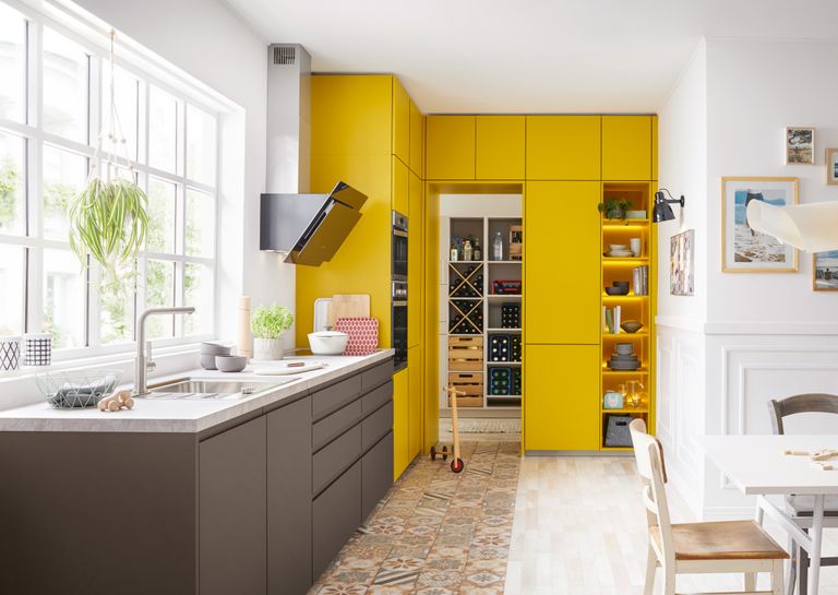 kitchen with yellow built in kitchen cabinets and patterned flooring