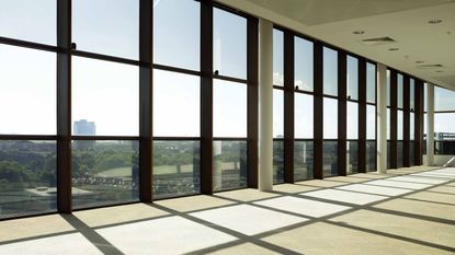 view looking out into city from floor to ceiling windows in office space
