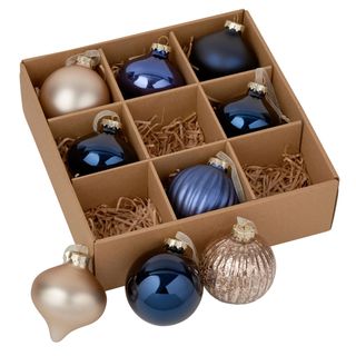 mixed glass christmas baubles in box with white background