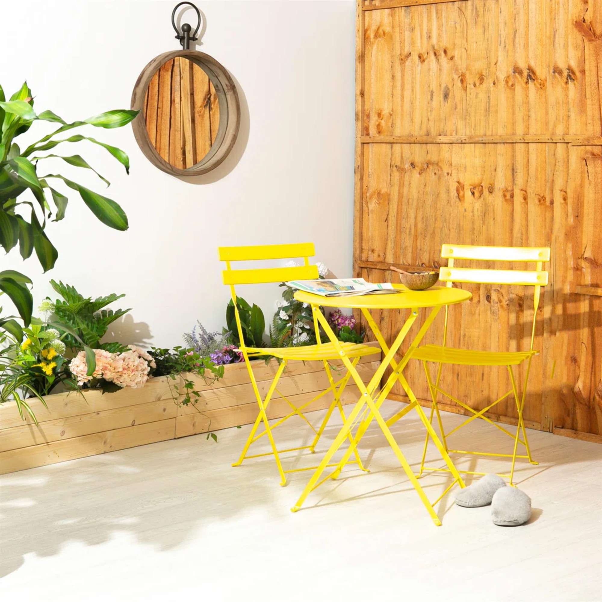 Harbour Housewares 2 Seater Sussex Bistro Set in yellow on a patio