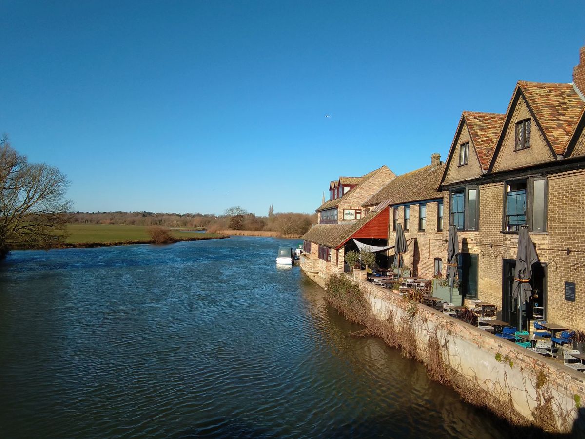 Houses overlooking a river on a sunny day