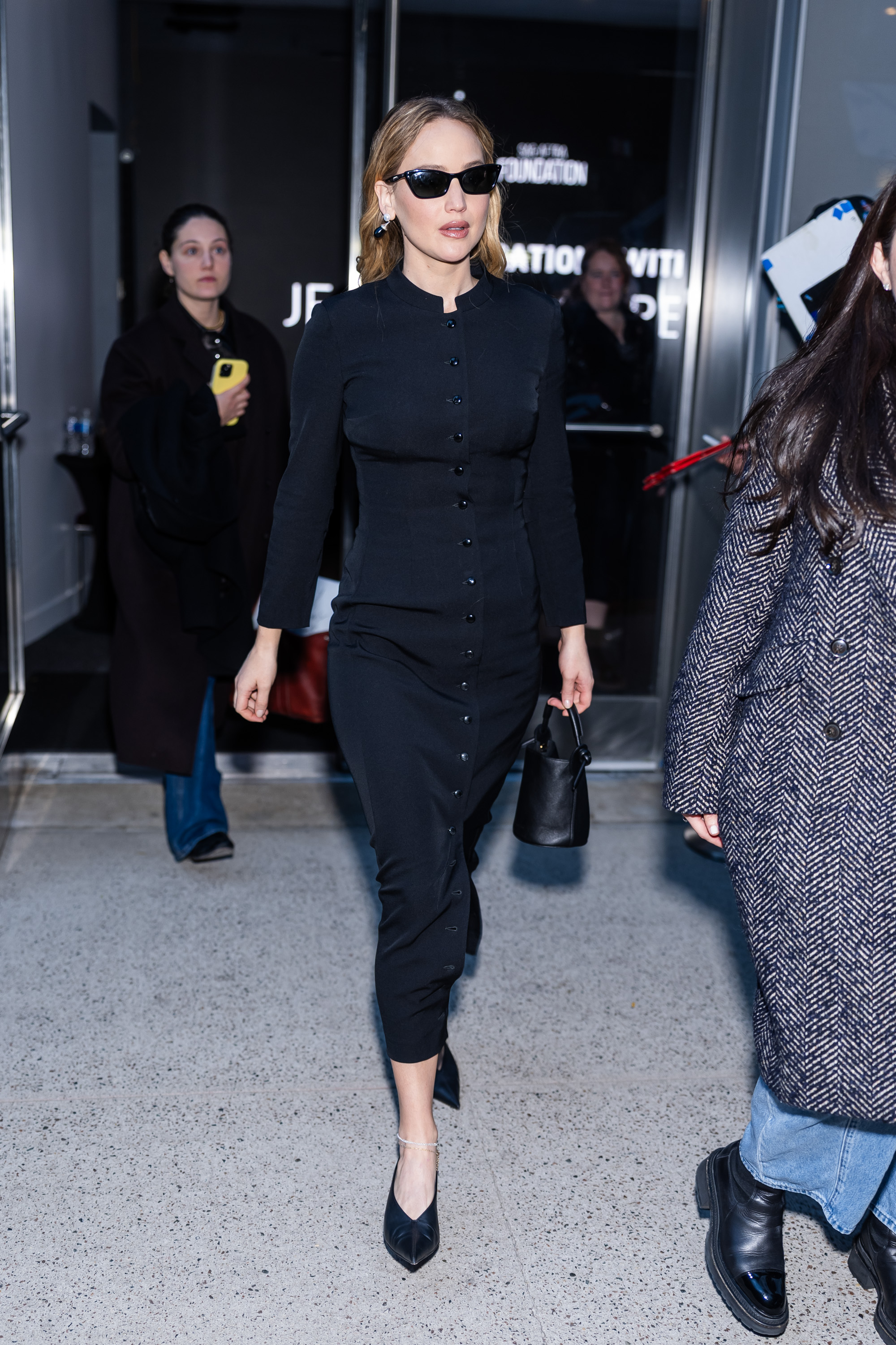 Jennifer Lawrence was spotted in a black Dolce &amp;amp; Gabbana shirt dress, plus a matching Mansur Gavriel bucket bag
