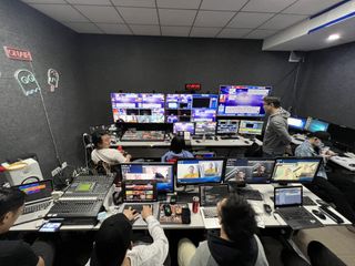 A control room of people and AJA solutions prepare for a live boradcast.