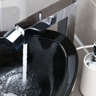 bathroom with silver tap and black sink