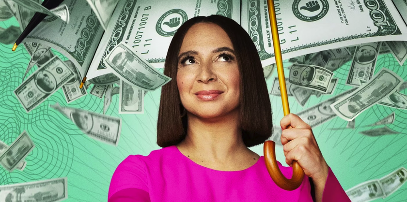 Maya Rudolph, star of Loot season 2, hold an umbrella up as cash rains down. 