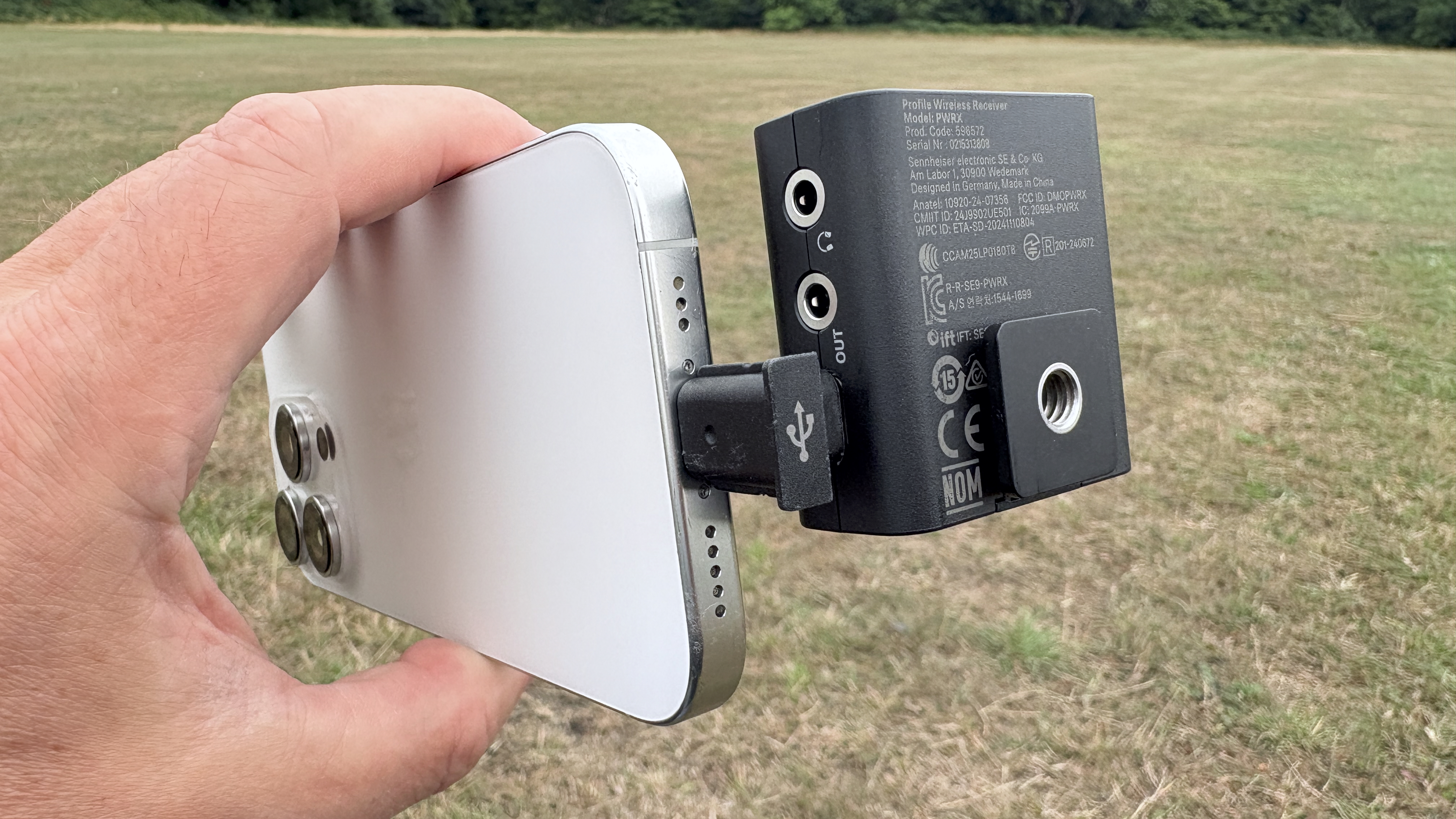 Close-up of the USB-C to USB-C adaptor connecting the receiver to an iPhone 16 Pro