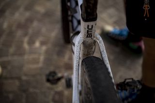A close up of the seatstays of the bike splattered in mud