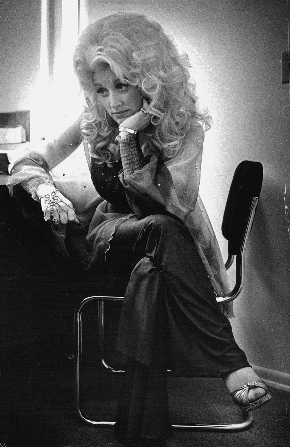 Dolly Parton looking pensive backstage