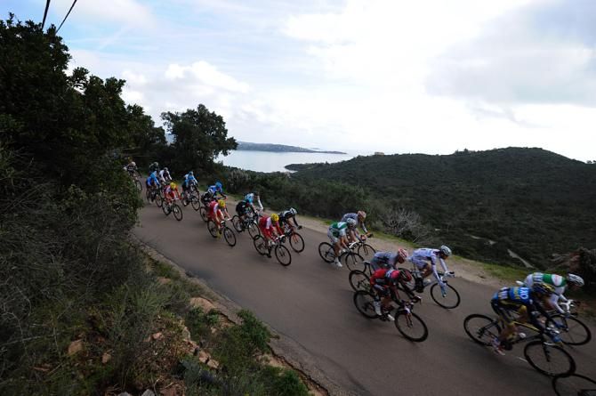 The peloton heads along the Corsican coast