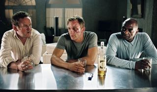 Colm Meany, Daniel Craig, and George Harris sit down for a drink in Layer Cake.