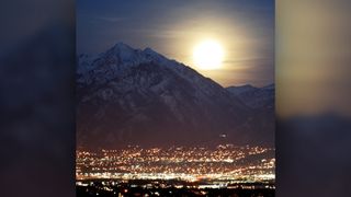 The moonrise over the Salt Lake City and the mountainous Wasatch Range in February 2012.