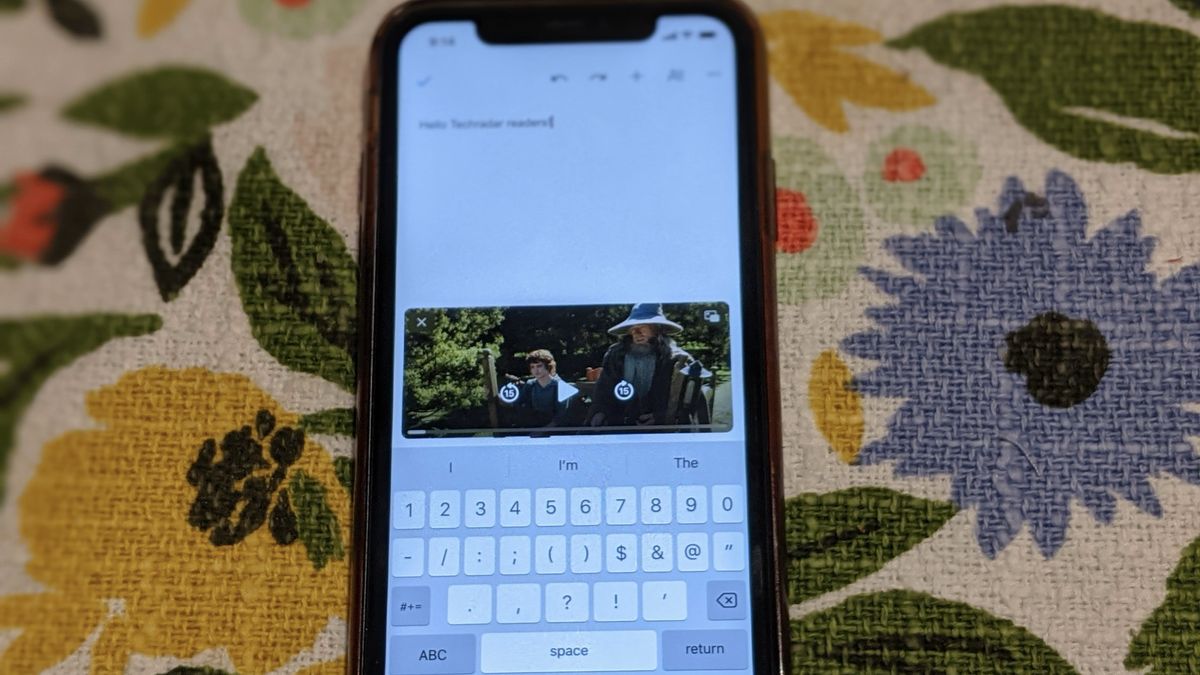 An iPhone with The Fellowship of the Ring on screen with Google Docs open