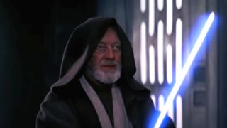 Alec Guinness stands with his lightsaber drawn in Star Wars.