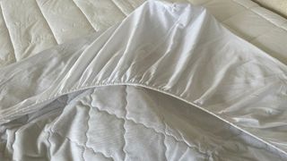 The elastic corner of a John Lewis Soft Touch Washable Quilted Mattress Protector