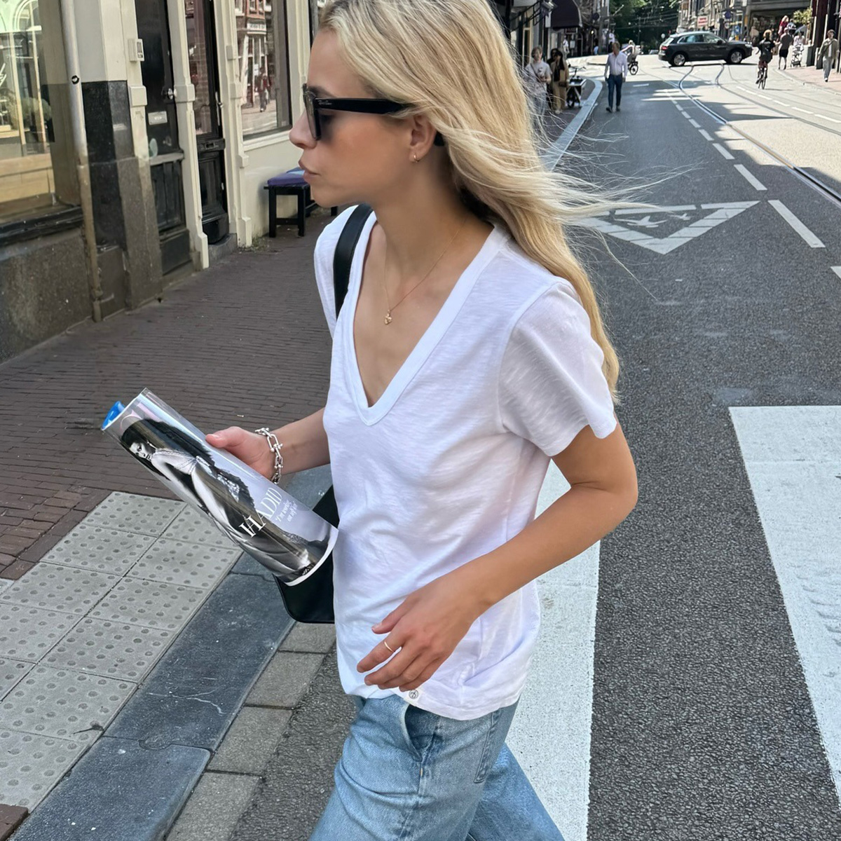 Stephanie Broek wearing a V-neck T-shirt with jeans.