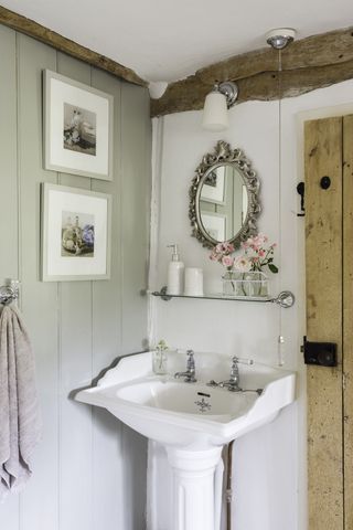 Period-style bathroom basin with panelling in thatched cottage