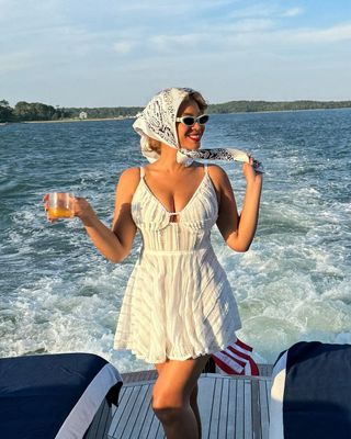 Beyonce poses on a boat wearing a short white dress