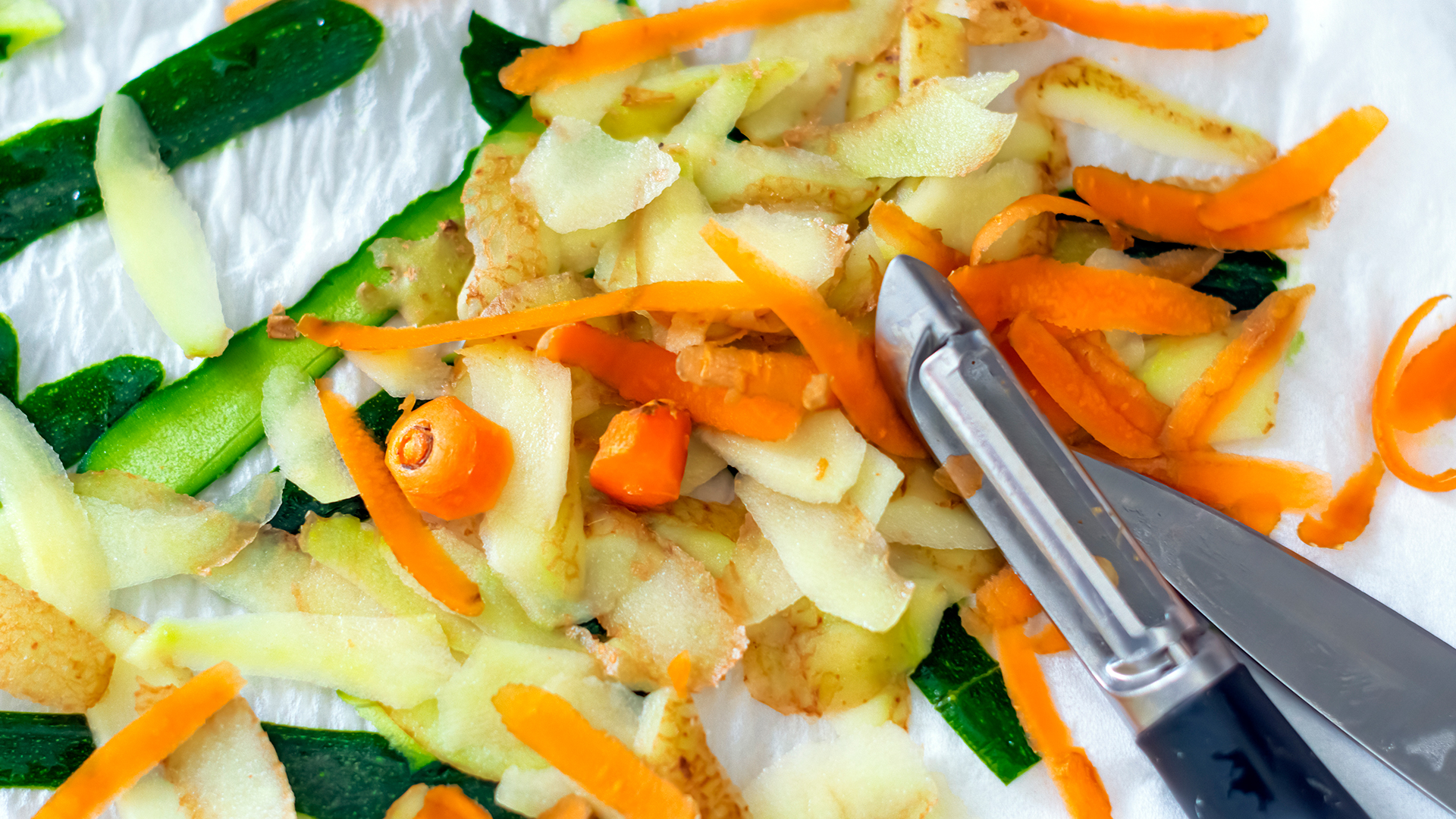 a pile of vegetable peelings with carrots, courgettes and potatoes