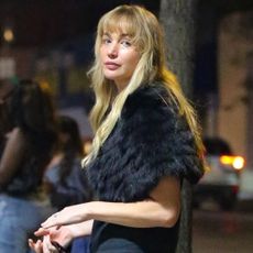 Jennifer Lawrence wore a fur shawl over her shoulders with La Ligne jeans and a five-figure The Row bag