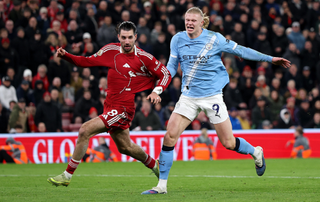 Dominik Szoboszlai of Liverpool fouls Erling Haaland of Manchester City leading to a red card following a VAR review during the Premier League match between Liverpool and Manchester City