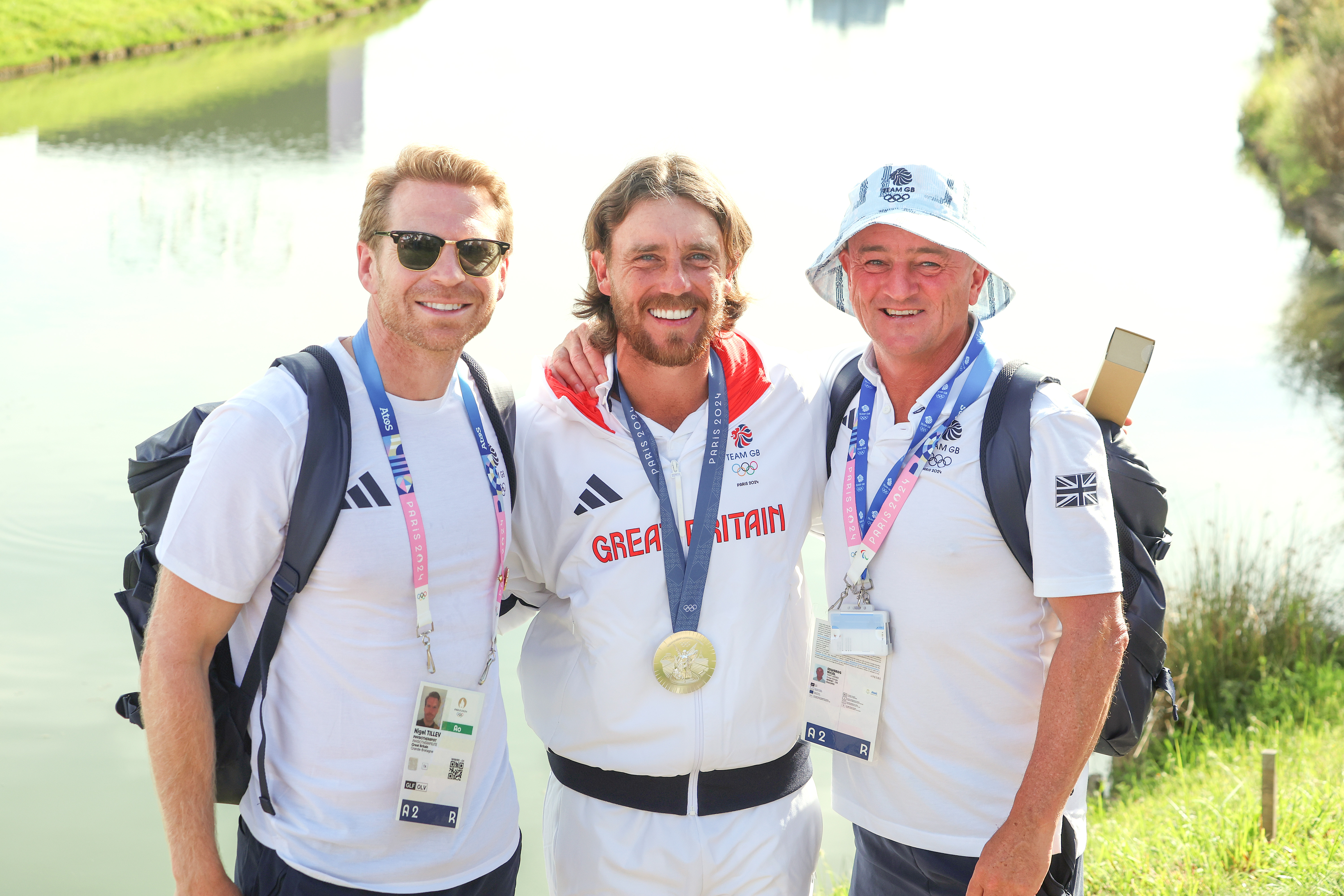 Nigel Tilley, Tommy Fleetwood and Nigel Edwards pose at the 2024 Paris Olympics