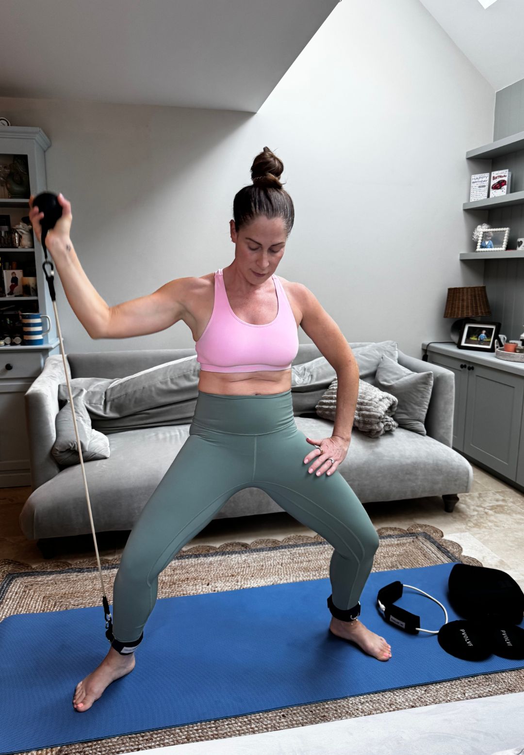 Health writer Anna Bartter trying the new Pvolve Sculpt Anywhere Bundle, at home in her gym kit