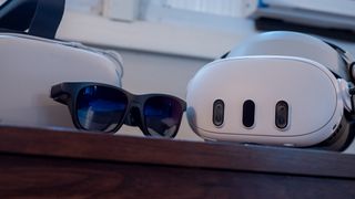 A Meta Quest 3, Meta Quest 2, and a pair of Viture One smart glasses together