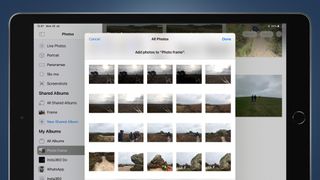 An iPad screen showing a grid of photos in the Photos app