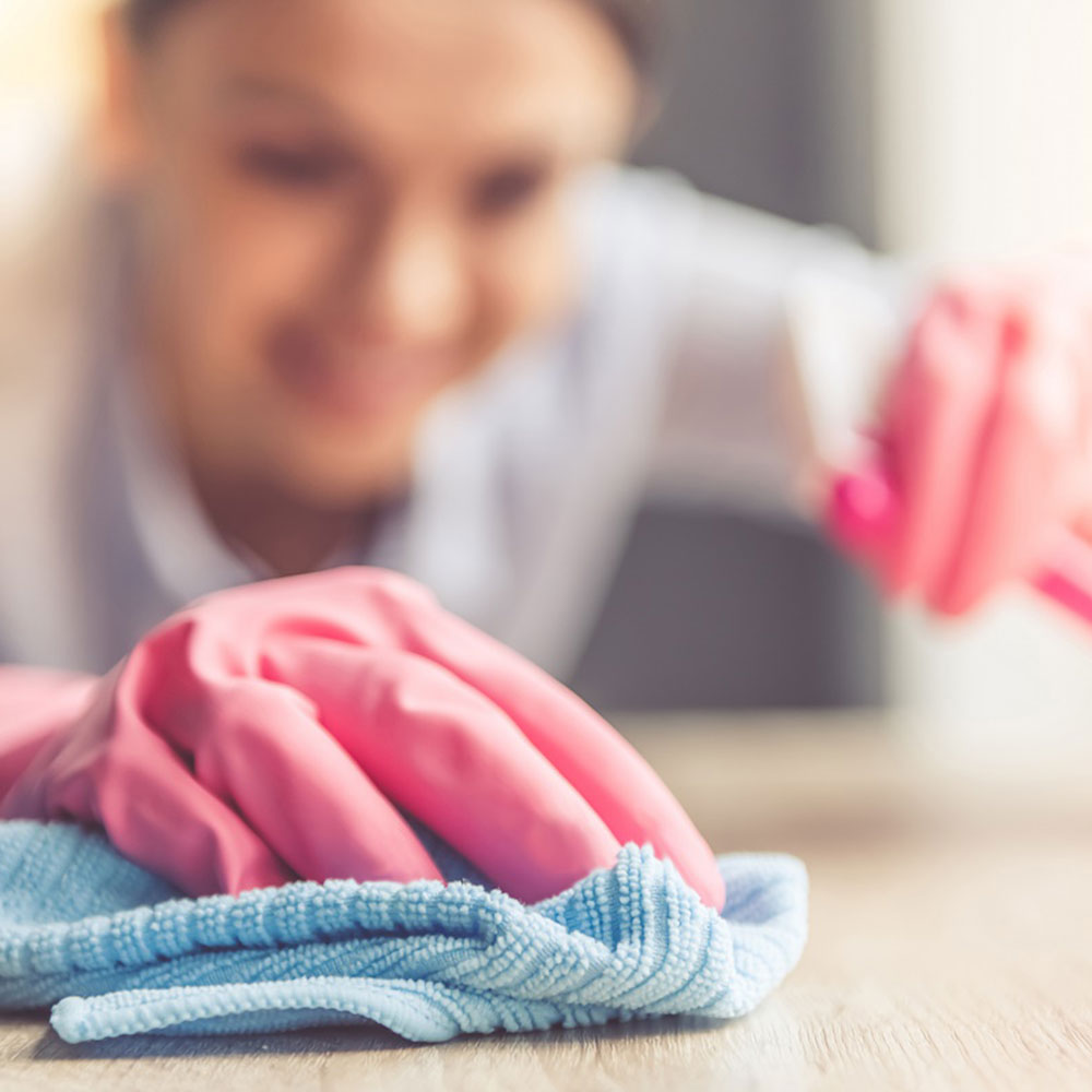 using safety gloves for cleaning table