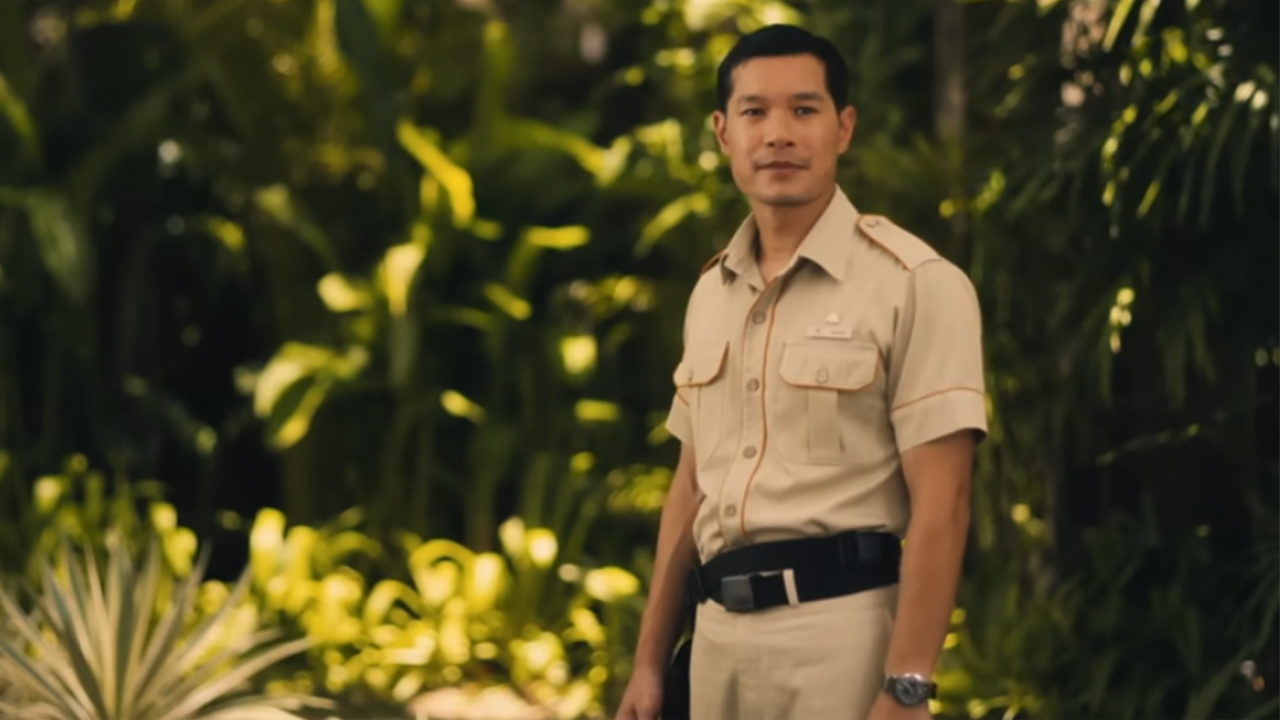 Tayme Thapthimthong in his security guard uniform in The White Lotus
