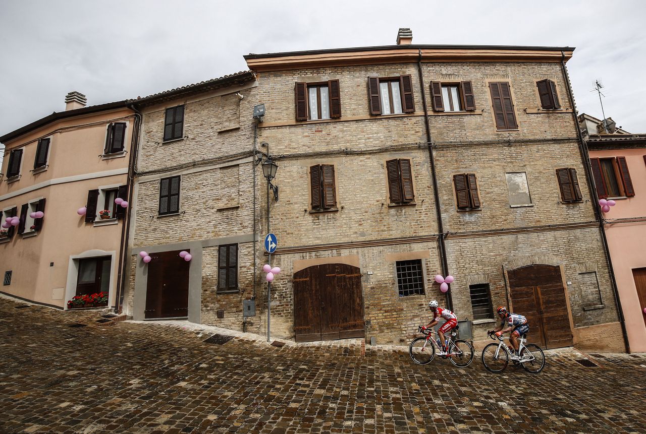 Riders pass through a picturesque town en route