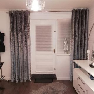 room with white door ceiling lamp door mat