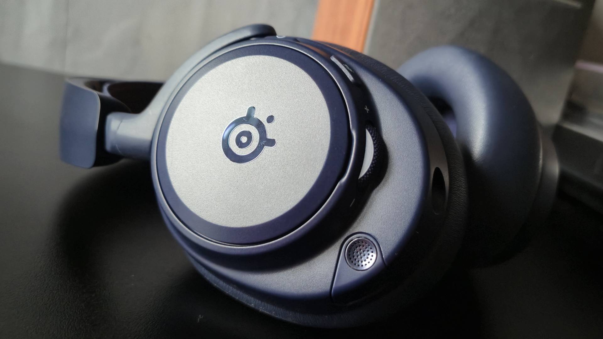 Image of the SteelSeries Arctis Nova Pro Omni headset sitting on a black surface.